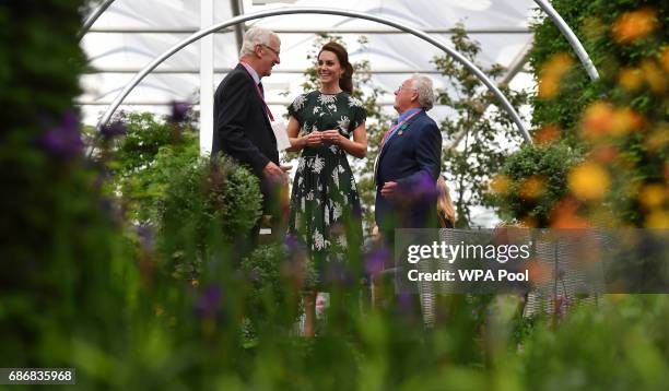 Catherine, Duchess of Cambridge talks with exhibitors as she views a parterre at the Hillier garden display at the RHS Chelsea Flower Show press day...