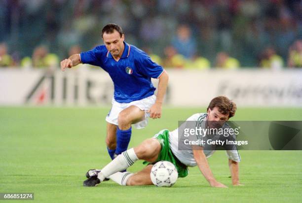 Republic of Ireland player Ray Houghton is challenged by Salvatore Schillaci during the 1990 FIFA World Cup quarter Final defeat against Italy at the...