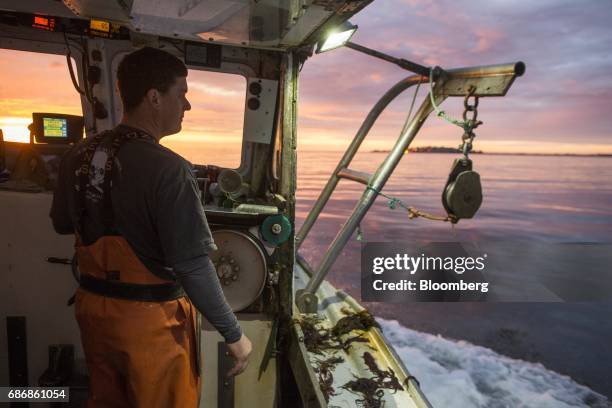 The boat captain watches lobster pots in the waters of Hull, Massachusetts, U.S., on Wednesday, May 17, 2017. New restrictions are coming to southern...