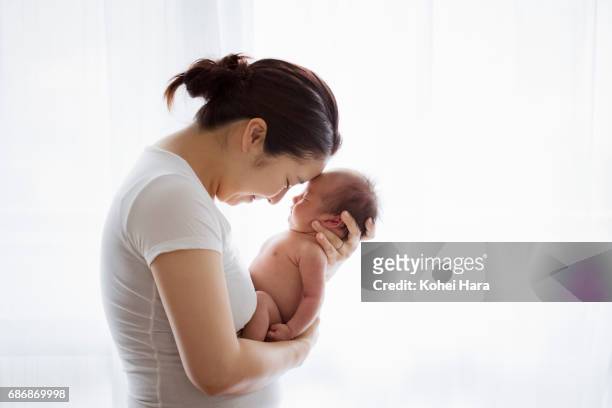 mother and baby relaxed at home - asian baby stock pictures, royalty-free photos & images