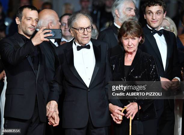 French actor Mathieu Kassovitz takes photos as he arrives on May 22, 2017 with French actor Jean-Louis Trintignant and his wife Marianne Hoepfner for...