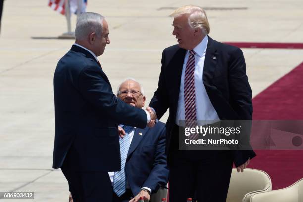 President Donald Trump shakes hands with Prime Minister Benjamin Netanyahu during an official welcoming ceremony on his arrival at Ben Gurion...