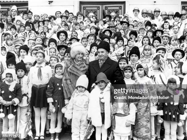 President of Romania Nicolae Ceausescu and his wife Elena together with a group of children wearing traditional costumes. Romania, 1980s