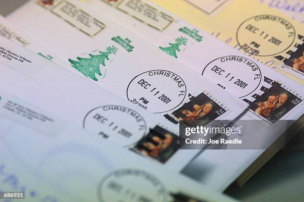 Letters with a Christmas, FL postmark sit on a post office counter December 11, 2001 in Christmas, FL. The letters are only a fraction of the...