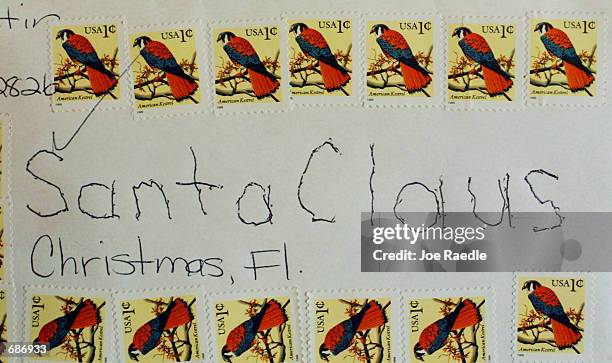 An envelope addressed to Santa Claus December 11, 2001 sits on a desk belonging to Jack James in Christmas, FL. James receives thousands of cards...