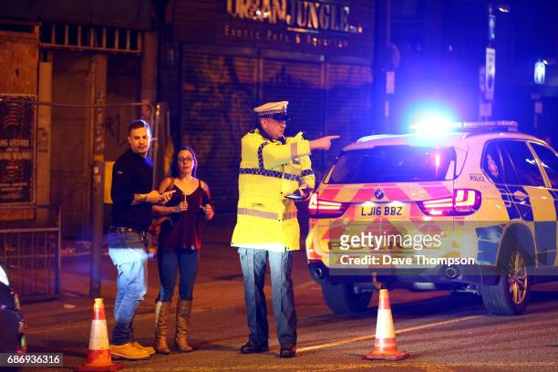 Police stand by a cordoned off street close to the Manchester Arena on May 22, 2017 in Manchester, England. There have been reports of explosions at...