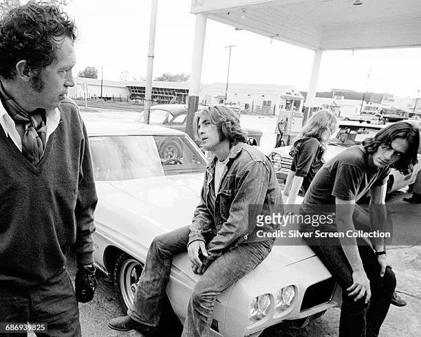 From left to right, actor Warren Oates as G.T.O, singer-songwriter James Taylor as The Driver, actress Laurie Bird as The Girl and Beach Boys drummer...