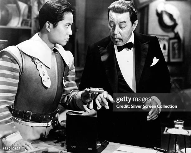 Actors Warner Oland and Keye Luke in a scene from the film 'Charlie Chan at the Opera', 1935.