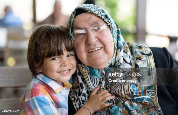 little boy with his grandmother - iranian culture stock pictures, royalty-free photos & images
