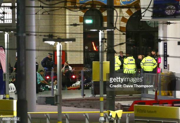 Members of the public receive treatment from emergency service staff at Victoria Railway Station close to the Manchester Arena on May 23, 2017 in...
