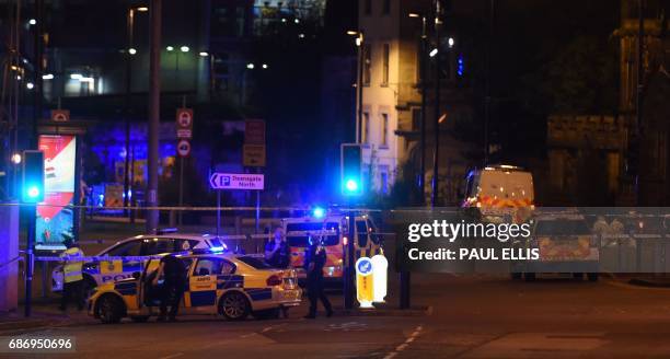 Police deploy at scene of a reported explosion during a concert in Manchester, England, on May 23, 2017. British police said early May 23 there were...