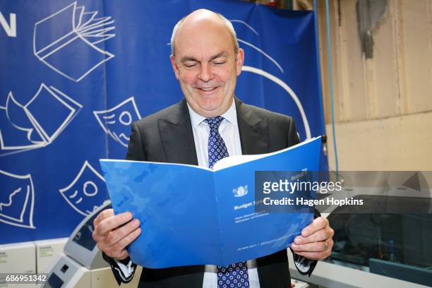 Finance Minister Steven Joyce looks over a copy of his budget speech during the printing of the budget at Printlink on May 23, 2017 in Wellington,...