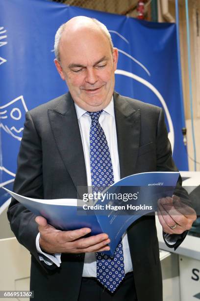 Finance Minister Steven Joyce looks over a copy of his budget speech during the printing of the budget at Printlink on May 23, 2017 in Wellington,...