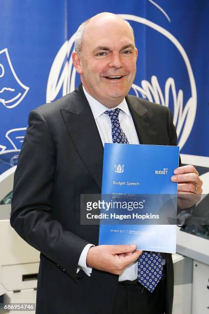 Finance Minister Steven Joyce poses with a copy of his budget speech during the printing of the budget at Printlink on May 23, 2017 in Wellington,...