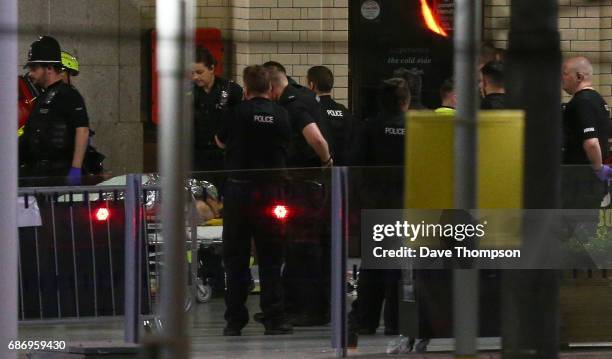 Person is wheeled away on a stretcher at Victoria Railway Station close to the Manchester Arena on May 23, 2017 in Manchester, England. An explosion...