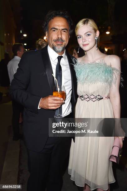 Alejandro Gonzalez Inarritu and Elle Fanning attend Fondazione Prada Private Dinner during the 70th annual Cannes Film Festival at Restaurant Fred...