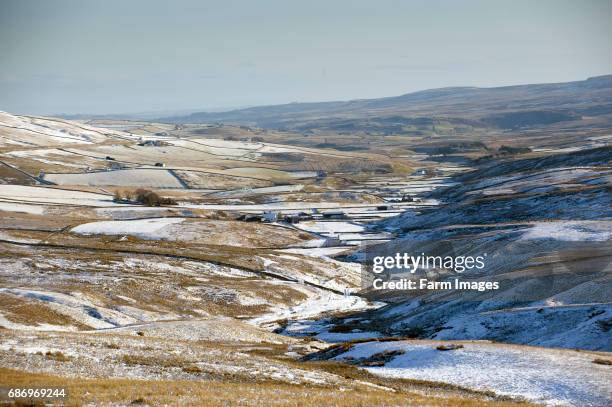 Looking down a snow covered Harwood in Teesdale from near Ashgill Head. Co. Durham - England.