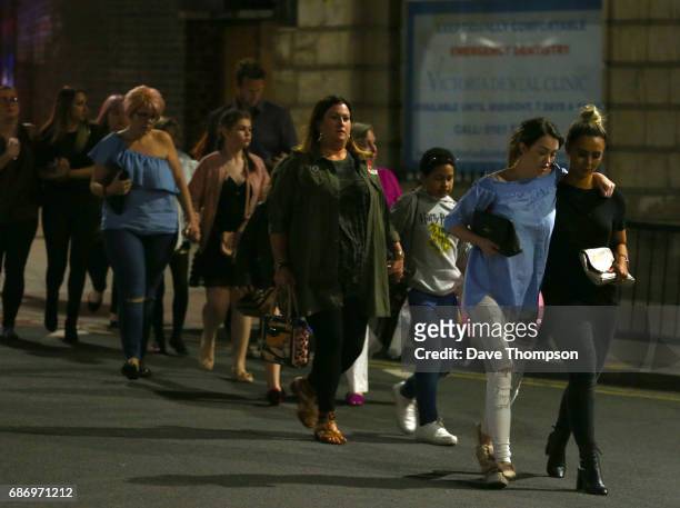 Members of the public are escorted from the Manchester Arena on May 23, 2017 in Manchester, England. An explosion occurred at Manchester Arena as...