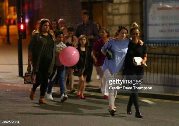 Members of the public are escorted from the Manchester Arena on May 23, 2017 in Manchester, England. An explosion occurred at Manchester Arena as...