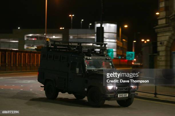 An armoured police Land Rover drives away from the Manchester Arena on May 23, 2017 in Manchester, England. An explosion occurred at Manchester Arena...