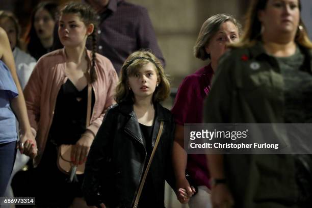 Police escort members of the public from the Manchester Arena on May 23, 2017 in Manchester, England. An explosion occurred at Manchester Arena as...