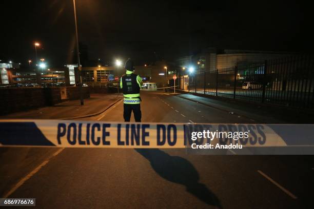 British police guard the entrance to the Manchester Arena stadium in Manchester, United Kingdom on May 23, 2017. A large explosion was reported...