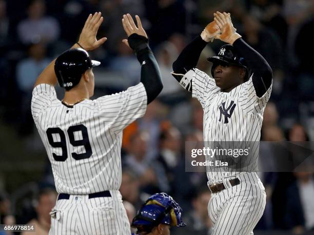 Aaron Judge congratulates teammate Didi Gregorius of the New York Yankees after Gregorius drove them both in with a two run home run in the fourth...