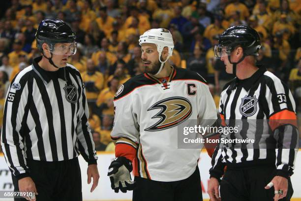 Anaheim Ducks center Ryan Getzlaf talks with referee Kevin Pollock and linesman Shane Heyer during Game 6 of the Western Conference Final between the...