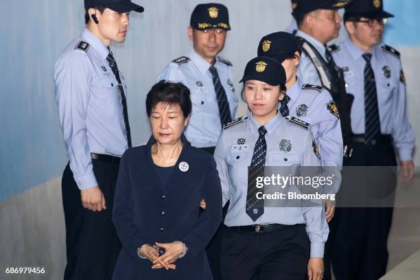 Park Geun-hye, former president of South Korea, front, is escorted by prison officers as she arrives at the Seoul Central District Court in Seoul,...