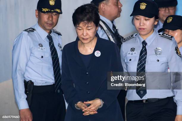Park Geun-hye, former president of South Korea, center, is escorted by prison officers as she arrives at the Seoul Central District Court in Seoul,...
