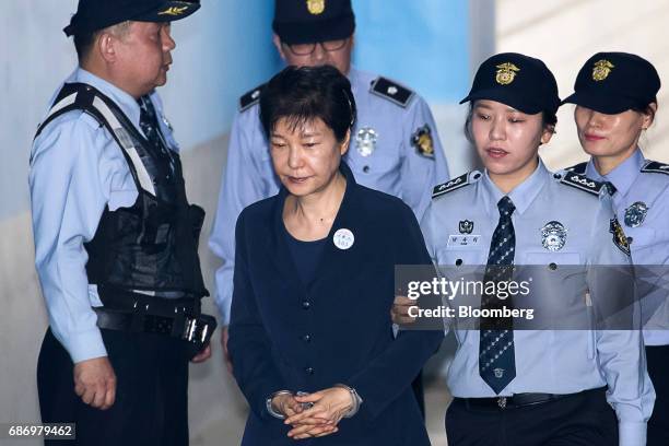 Park Geun-hye, former president of South Korea, center, is escorted by prison officers as she arrives at the Seoul Central District Court in Seoul,...
