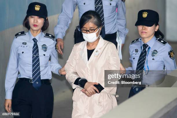 Choi Soon-sil, a long-time friend of South Korea's former President Park Geun-hye, center, is escorted by prison officers as she arrives at the Seoul...