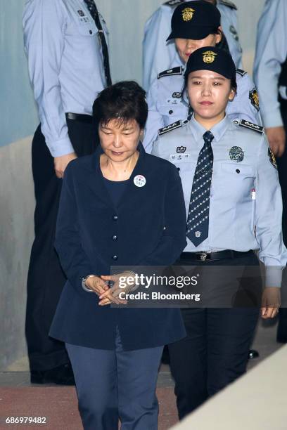 Park Geun-hye, former president of South Korea, left, is escorted by prison officers as she arrives at the Seoul Central District Court in Seoul,...