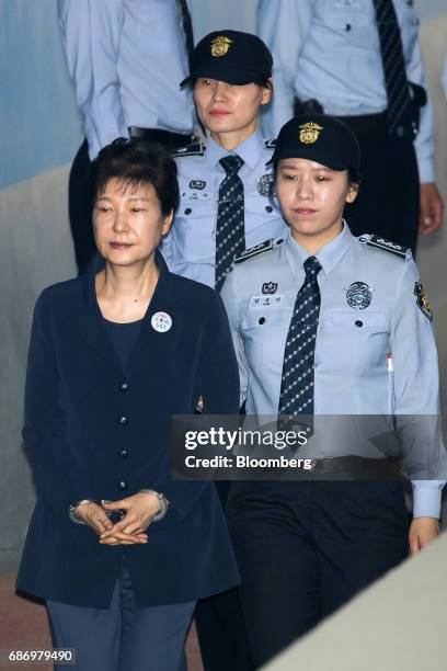 Park Geun-hye, former president of South Korea, left, is escorted by prison officers as she arrives at the Seoul Central District Court in Seoul,...