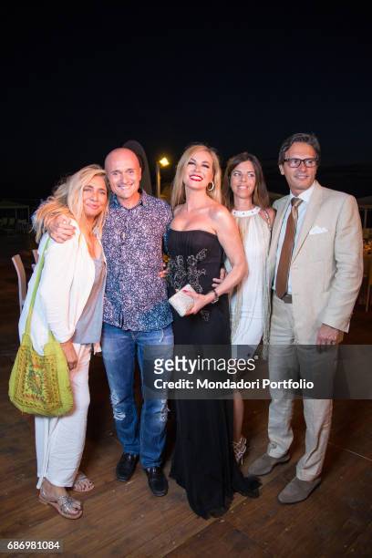 Host Mara Venier , Alfonso Signorini, director of Chi, and TV host Federica Panicucci having dinner in the beach resort Ostras Beach during the event...