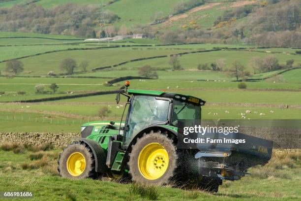 John Deere 6126r spreading fertiliser on upland pasture, Lancashire, UK.