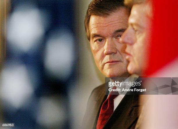 Canadian Minister of Foreign Affairs John Manley answers questions from the press as U.S. Homeland Security Director Tom Ridge looks on December 12,...