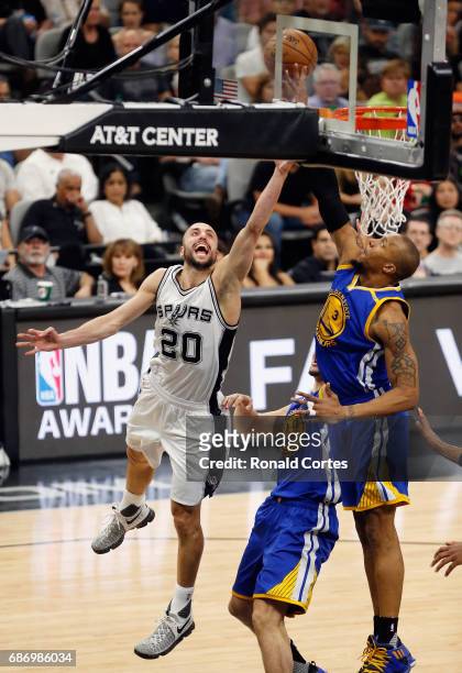 Manu Ginobili of the San Antonio Spurs drives to the basket against David West of the Golden State Warriors in the first half during Game Four of the...