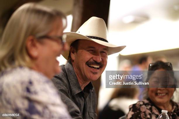 Democratic U.S. Congressional candidate Rob Quist talks with supporters during a gathering at Darkhorse Hall and Wine Snug on May 22, 2017 in Great...