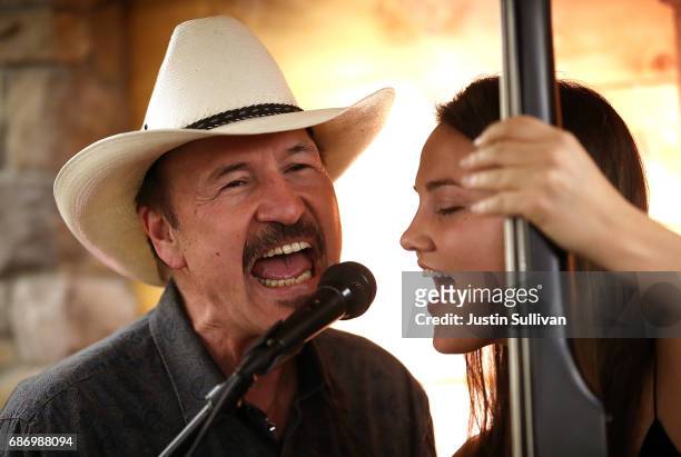 Democratic U.S. Congressional candidate Rob Quist performs a song with his daughter Halladay Quist during a gathering with supporters at Darkhorse...