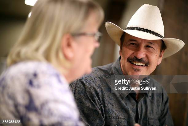 Democratic U.S. Congressional candidate Rob Quist talks with supporters during a gathering at Darkhorse Hall and Wine Snug on May 22, 2017 in Great...