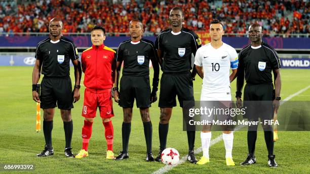 Referee Sidi Alioum of Cameroon, center, with his officiating team and Quang Hai Nguyen of Vietnam and Clayton Lewis of New Zealand before the FIFA...