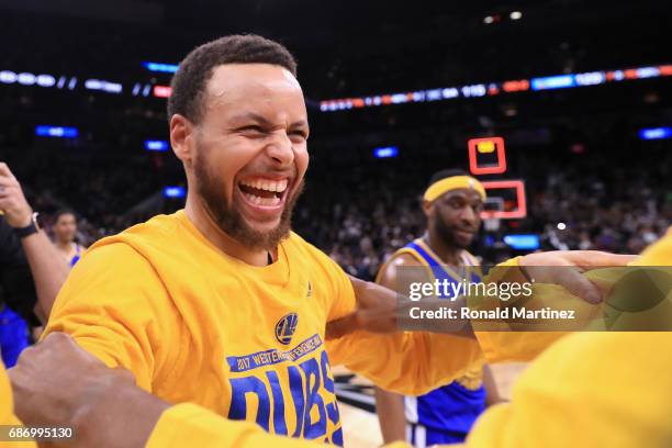 Stephen Curry of the Golden State Warriors celebrates with teammates after defeating the San Antonio Spurs 129-115 in Game Four of the 2017 NBA...