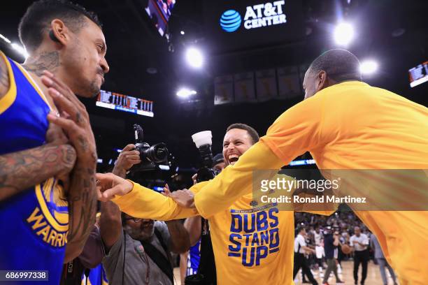 Stephen Curry of the Golden State Warriors celebrates with teammates after defeating the San Antonio Spurs 129-115 in Game Four of the 2017 NBA...