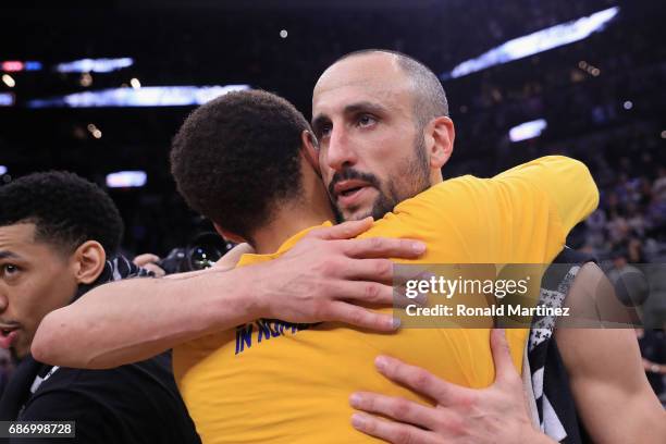 Stephen Curry of the Golden State Warriors hugs Manu Ginobili of the San Antonio Spurs after the Golden State Warriors defeated the San Antonio Spurs...