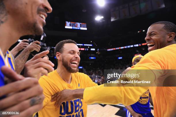 Stephen Curry of the Golden State Warriors celebrates with Andre Iguodala after defeating the San Antonio Spurs 129-115 in Game Four of the 2017 NBA...