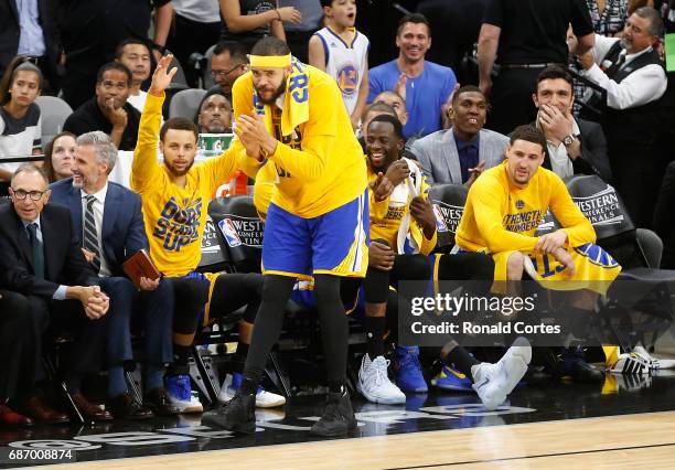 Stephen Curry, JaVale McGee, Draymond Green and Klay Thompson of the Golden State Warriors react on the bench in the second half against the San...