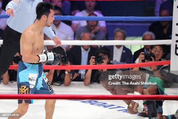 Ryota Murata of Japan knocks down Hassan N'Dam N'Jikam of France in the fourth round during the WBA World Middleweight title bout at Ariake Colosseum...