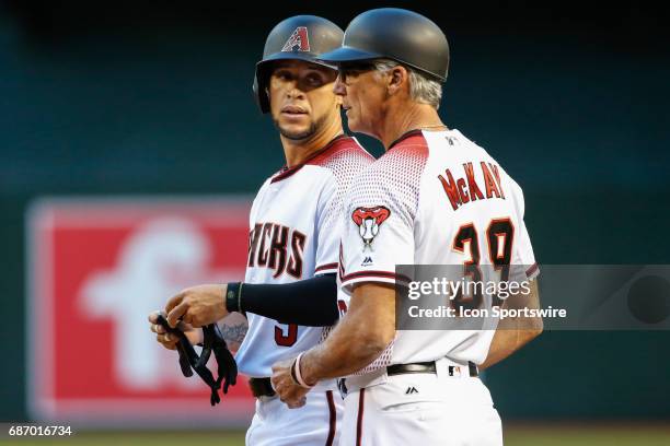 Arizona Diamondbacks right fielder Gregor Blanco talks to Arizona Diamondbacks first base coach Dave McKay after hitting a single during the MLB...