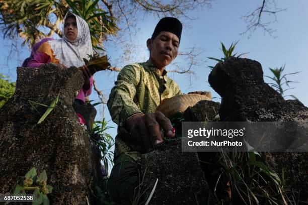 Javanese follows Nyadran ritual at Sewu Cemetery, Yogyakarta, Indonesia on May 22, 2017. Nyadran ritual is a tradition to clean up and pray to their...